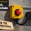 Ilustración: contra una pared de hormigón visto, una caja amarilla de fundición con un pulsador rojo de parada de emergencia, conectada por un cable negro a una unidad de servidor apagada sobre una ménsula. Abajo a la izquierda, una etiqueta de cartulina dice «110 TB asegurados». Arriba a la izquierda, un recuadro gris oscuro dice «Operación KillSwitch» y «KillSec, desconectado».