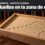 Ilustración con una metáfora visual: en una biblioteca de lomos de cuero, una caja de arena de madera clara rastrillada, cruzada por huellas mecánicas diminutas que dan una vuelta sin salir de la caja; adelante, un pequeño rastrillo de bronce. Arriba, en una franja oscura, el logo de Wikipedia, el texto «Wikimedia · Agentes de OpenAI» y el titular «Huellas en la zona de ensayo».